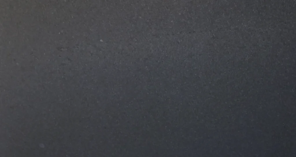 Close-up of a polished Black Pearl granite slab with deep charcoal and black tones available for countertops in Knoxville, Tennessee.