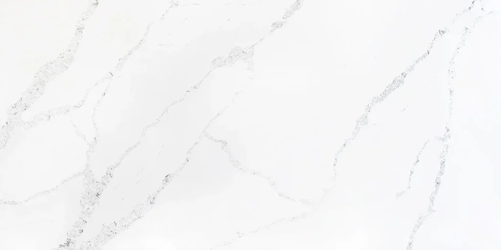 Close-up of a Calacatta Sienna quartz slab featuring a bright white background with elegant soft gray veining available in Knoxville, Tennessee.