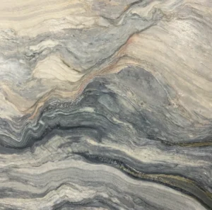 Close-up of a Fusion quartzite slab featuring dramatic flowing gray, cream, beige, and charcoal movement for luxury countertops in Knoxville, Tennessee.