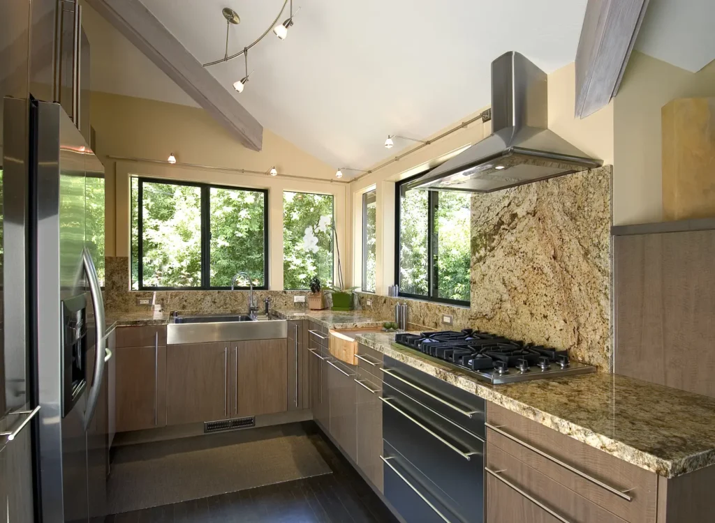 Modern kitchen featuring custom granite countertops, full-height granite backsplash, and matching countertops installed in Knoxville, Tennessee.