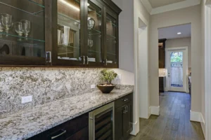 Custom quartzite countertop and backsplash installed in a home bar area in East Tennessee