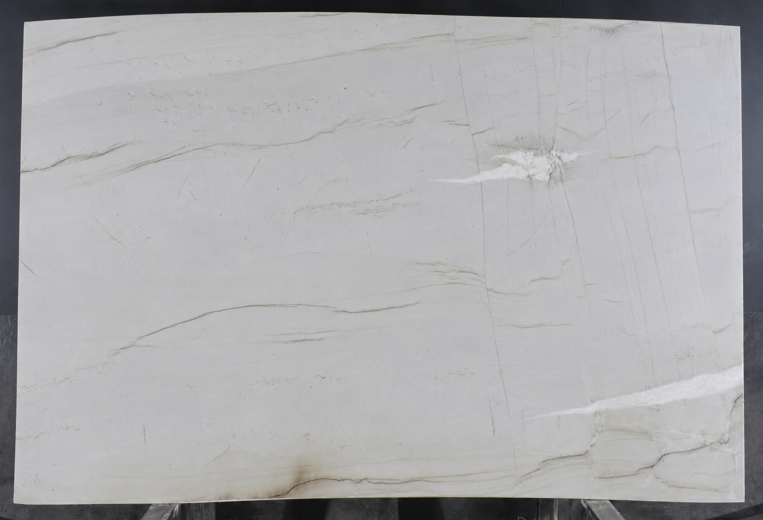 Mont Blanc quartzite slab with a soft white background and subtle gray and beige natural veining.