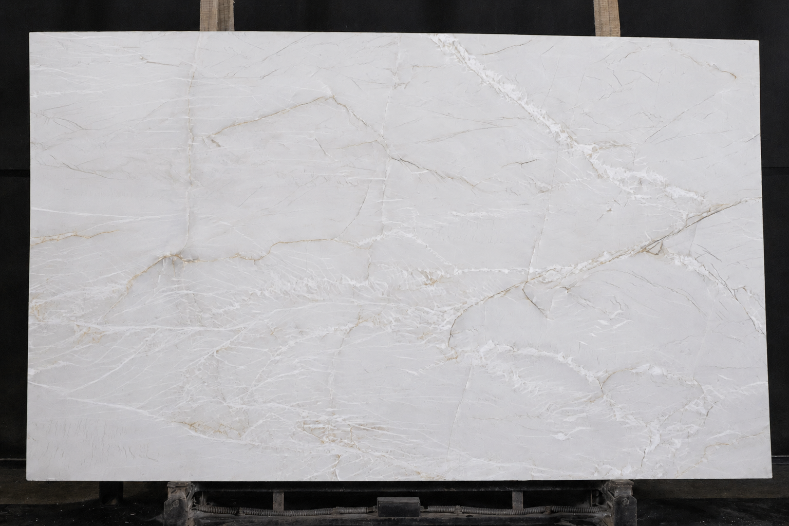 Mont Blanc quartzite slab with a soft white background and delicate beige and ivory natural veining.
