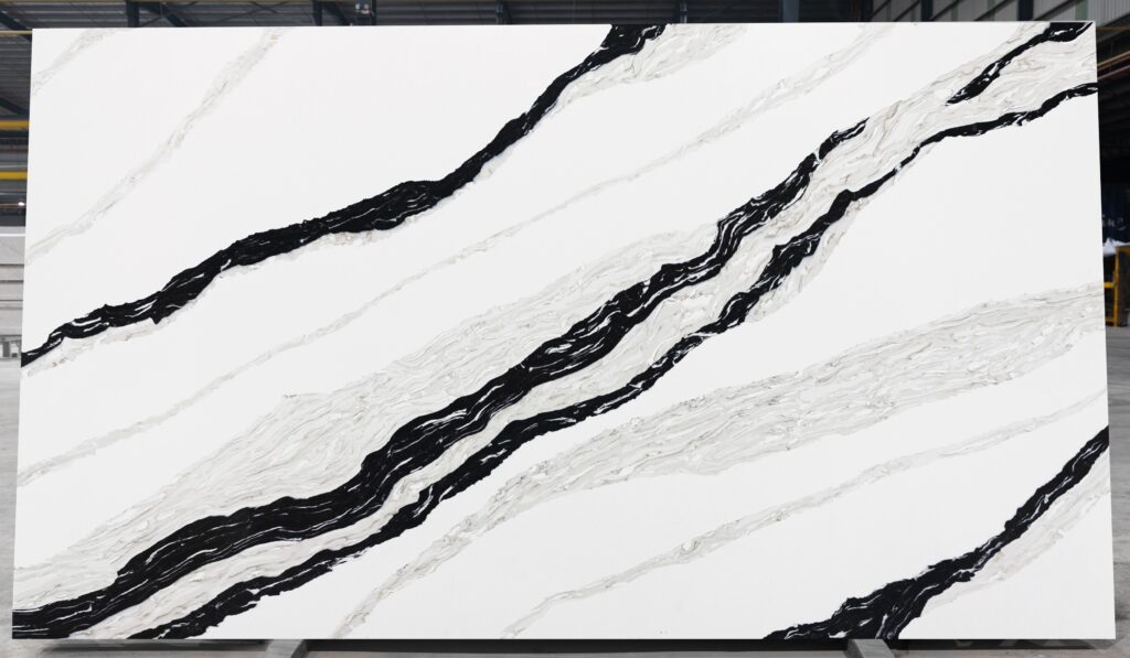 Panda White quartz slab with a bright white background and dramatic black and soft gray veining.